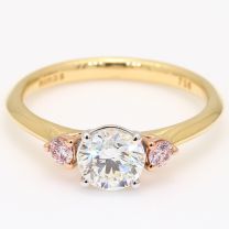 Luminous Argyle pink and white round cut diamond three stone engagement ring